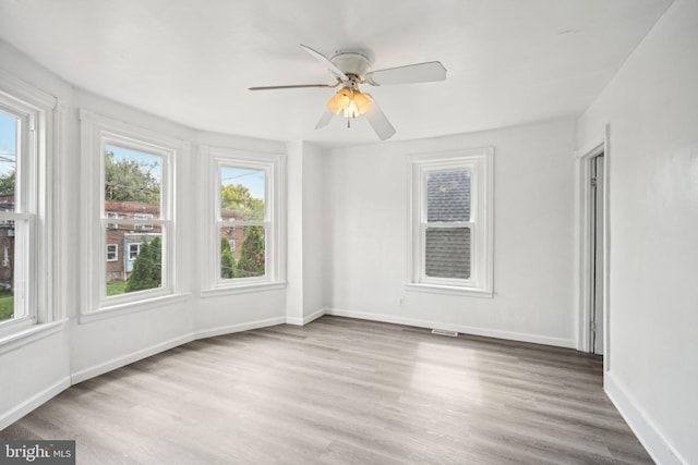 unfurnished room featuring light hardwood / wood-style floors and ceiling fan