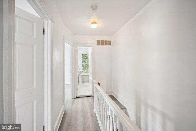 corridor featuring hardwood / wood-style floors