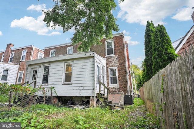 back of property featuring central AC unit