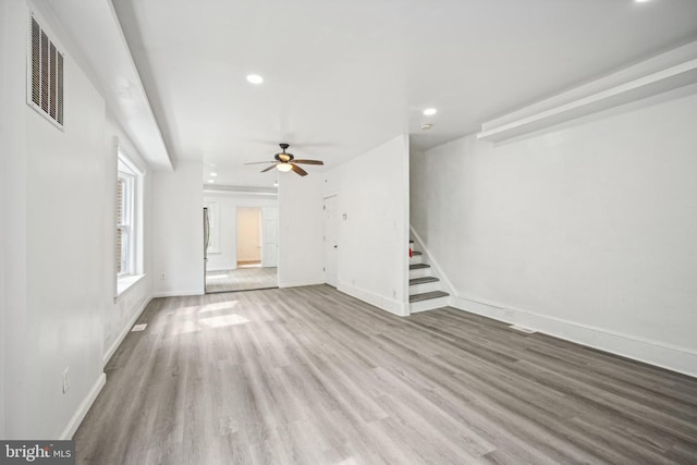 unfurnished living room featuring light hardwood / wood-style floors and ceiling fan