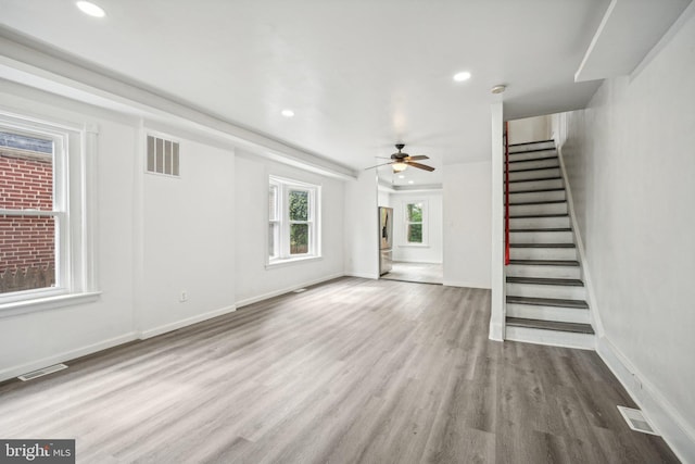 unfurnished living room featuring hardwood / wood-style floors and ceiling fan