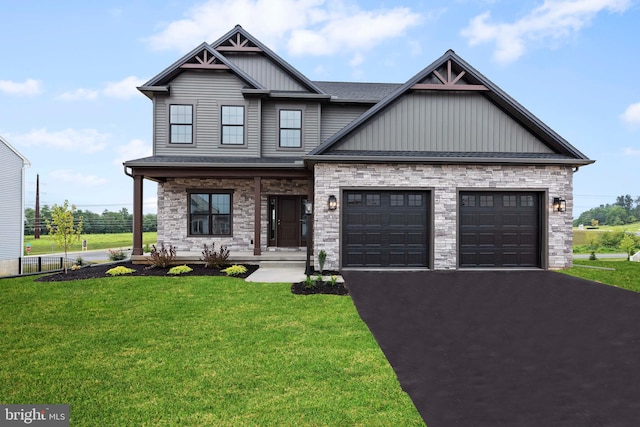 craftsman-style home featuring a front lawn, covered porch, and a garage