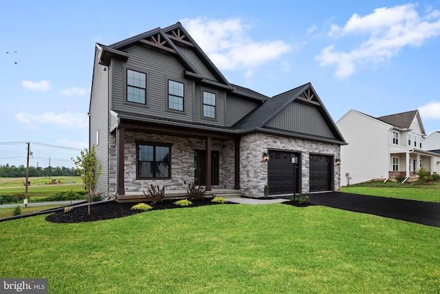 view of front facade featuring a front lawn, driveway, stone siding, board and batten siding, and an attached garage