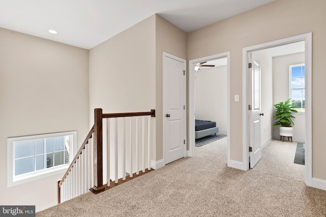 hall featuring an upstairs landing, recessed lighting, baseboards, and carpet