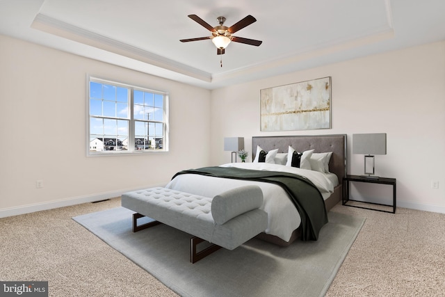 bedroom featuring a tray ceiling, baseboards, and carpet floors