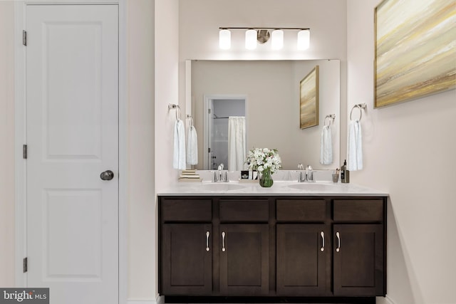 bathroom featuring double vanity and a sink