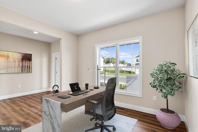 home office with dark hardwood / wood-style floors