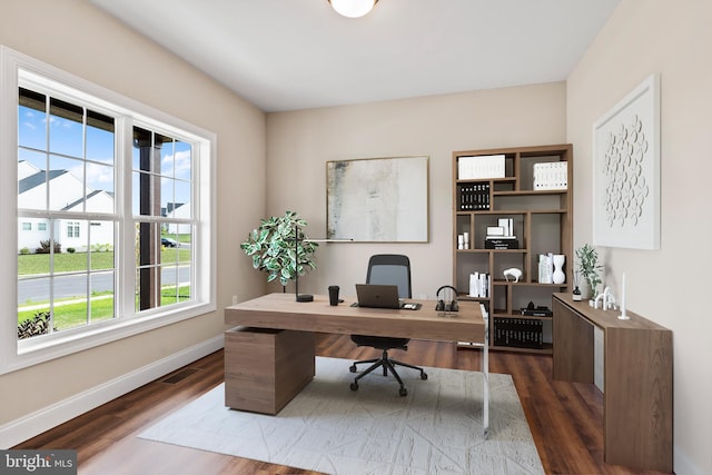 office featuring dark wood-type flooring and a wealth of natural light