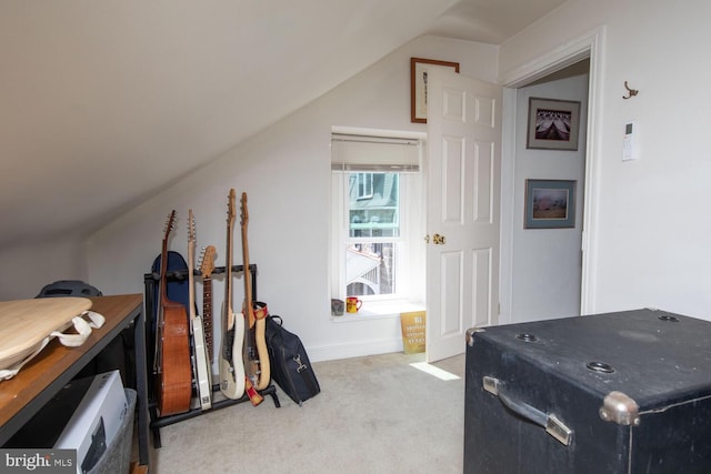 interior space with light colored carpet and vaulted ceiling