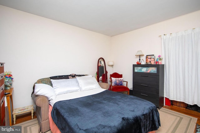 bedroom with hardwood / wood-style flooring