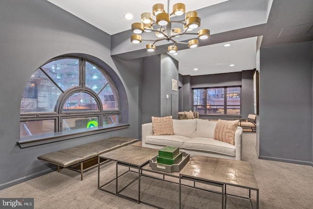 carpeted living room featuring an inviting chandelier