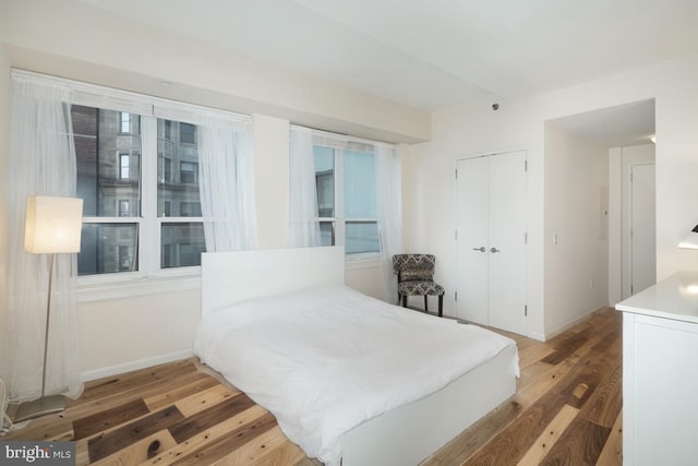 bedroom featuring a closet and dark hardwood / wood-style floors