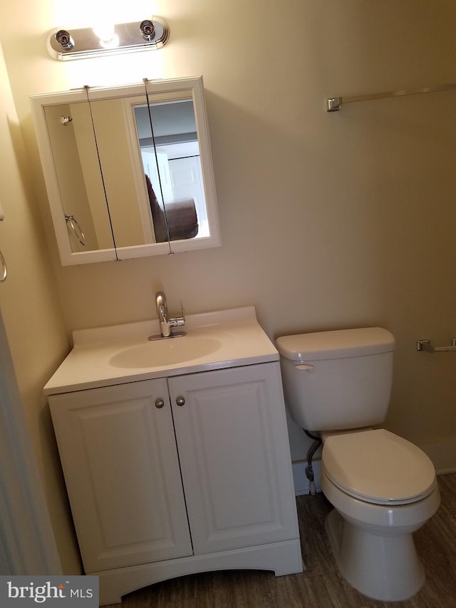 bathroom with vanity, hardwood / wood-style floors, and toilet