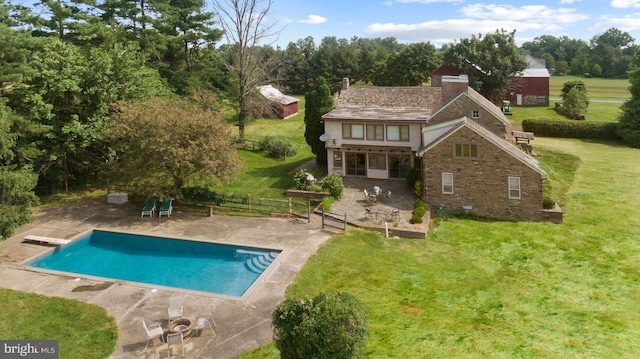 rear view of house featuring a patio area and a lawn