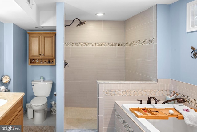 bathroom featuring vanity, tiled shower, toilet, and tile patterned floors