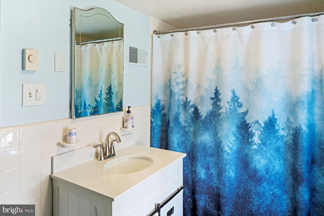 bathroom featuring tile walls and vanity