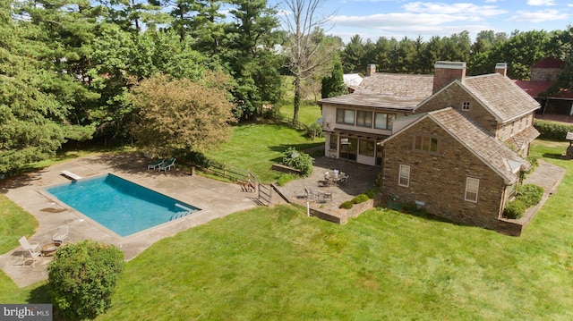 exterior space with a yard, a patio area, and a diving board