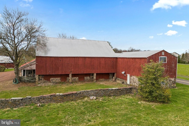 view of side of property with a yard