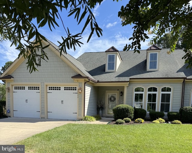 view of front of house featuring a garage and a front lawn