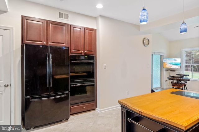 kitchen featuring light tile patterned flooring, decorative light fixtures, vaulted ceiling, and black appliances