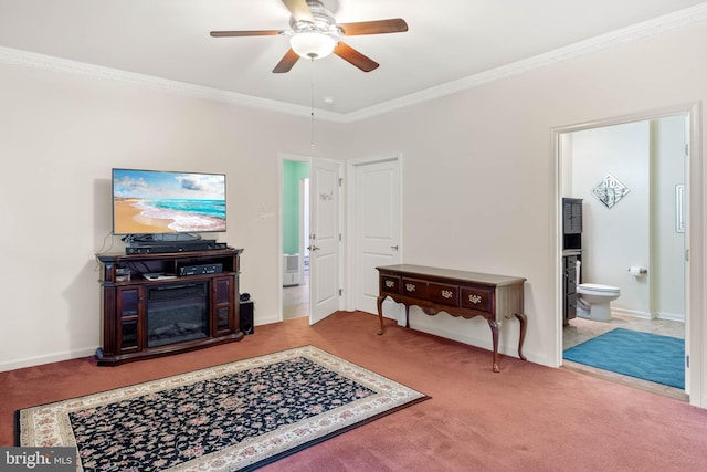 carpeted living room featuring ceiling fan, a fireplace, and ornamental molding