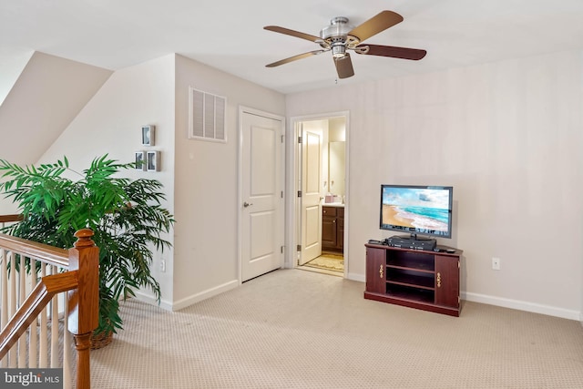 interior space featuring ceiling fan and light colored carpet