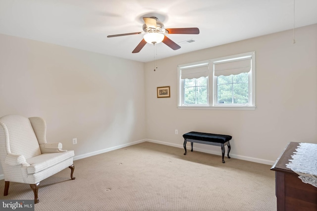 living area featuring ceiling fan and light carpet