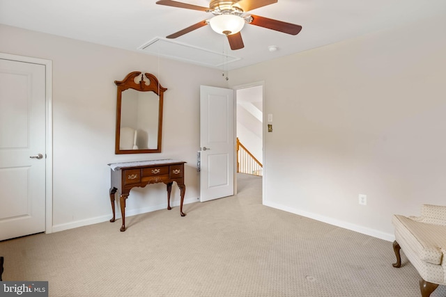 interior space featuring light carpet and ceiling fan