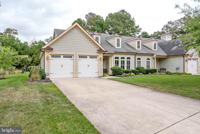 view of front of property featuring a front yard and a garage