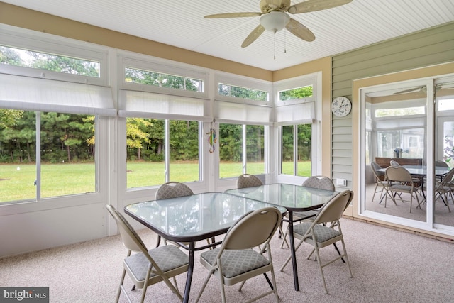 sunroom / solarium featuring ceiling fan