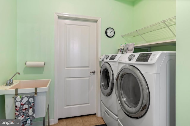 laundry room featuring washer and clothes dryer and light tile patterned floors