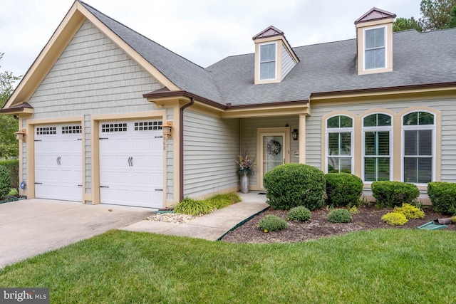 view of front of home featuring a front lawn and a garage