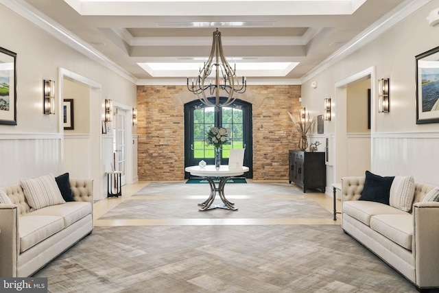 carpeted living room featuring ornamental molding, a tray ceiling, and a chandelier