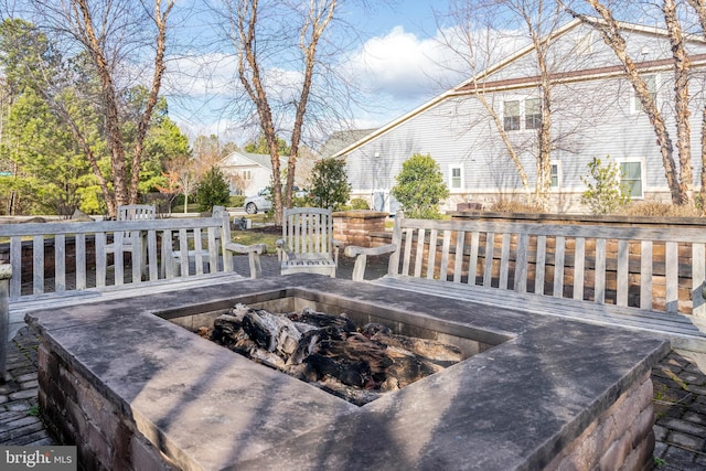 wooden deck featuring an outdoor fire pit