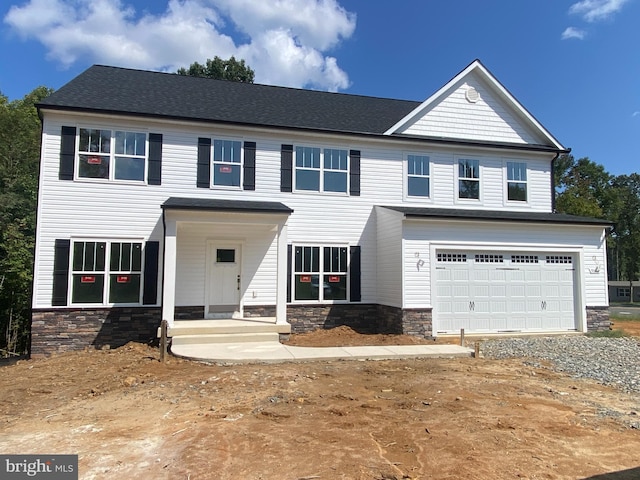 view of front facade featuring a porch and a garage