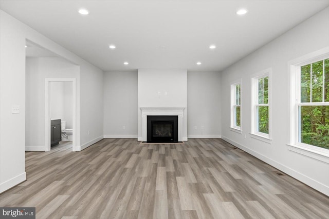 unfurnished living room featuring light hardwood / wood-style floors