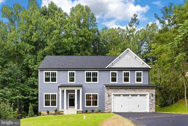 view of front of house featuring a garage and a front lawn