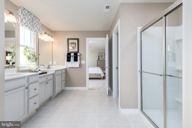 bathroom with tile patterned flooring, an enclosed shower, and vanity