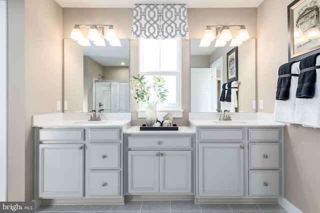 bathroom featuring walk in shower, vanity, and tile patterned flooring