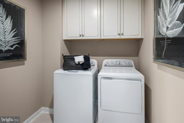 laundry room with cabinets and separate washer and dryer