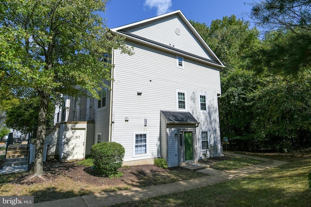 back of property with a balcony