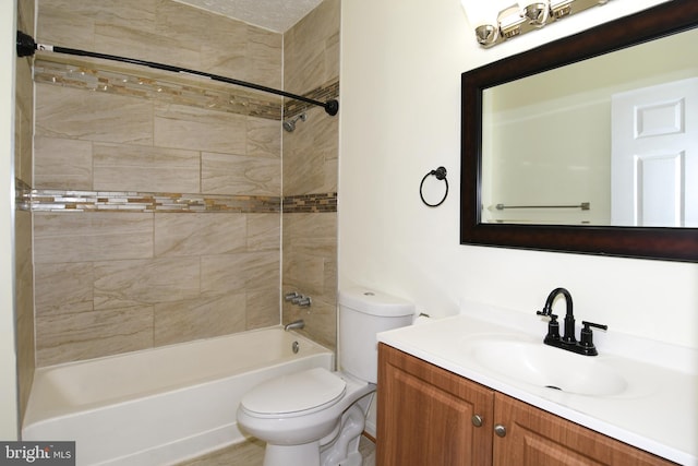 full bathroom featuring tiled shower / bath combo, vanity, and toilet