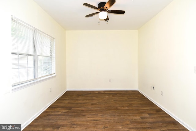 empty room with dark hardwood / wood-style flooring and ceiling fan