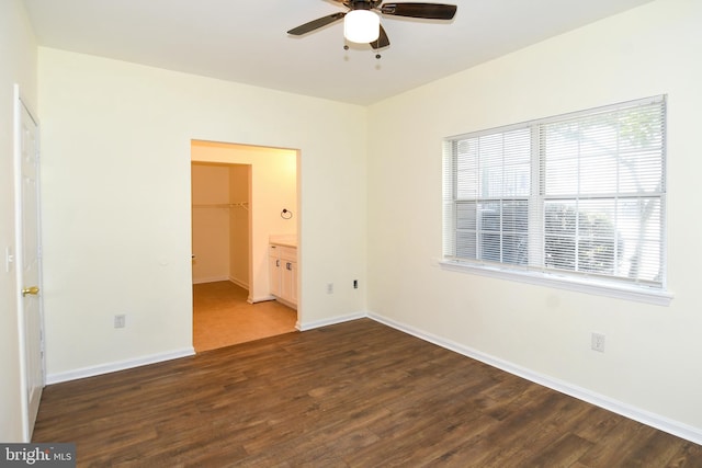 unfurnished room with ceiling fan and dark hardwood / wood-style flooring