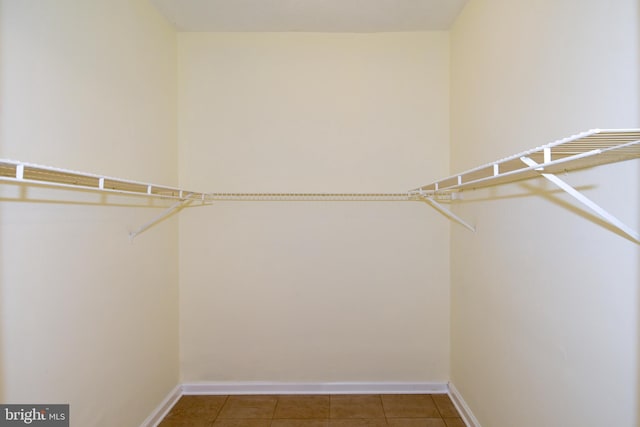 walk in closet featuring tile patterned flooring