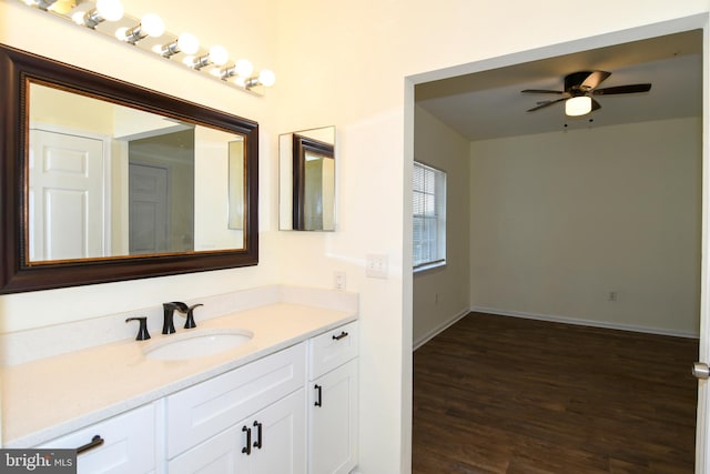 bathroom with wood-type flooring, vanity, and ceiling fan