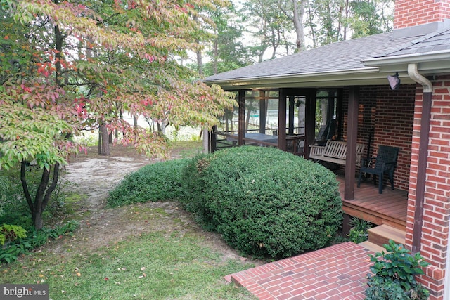 view of yard featuring a sunroom