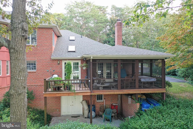 back of house featuring a sunroom