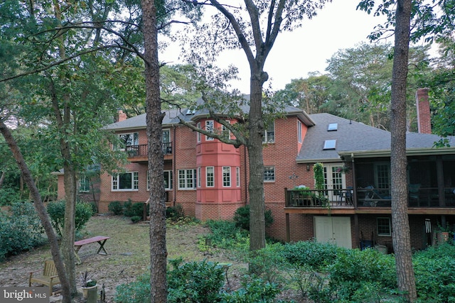 rear view of property with a sunroom