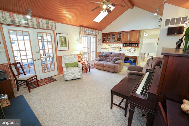 carpeted living room featuring high vaulted ceiling, beamed ceiling, french doors, and ceiling fan